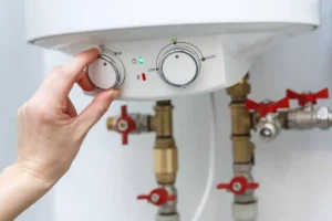 Plumber inspecting a water heater to diagnose why the water isn't heating up